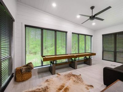 Shuffleboard and floor to ceiling windows.