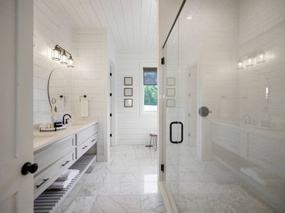 Attached private bathroom with double vanity, walk-in shower and tub.