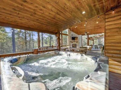 Large outdoor hot tub ready to warm you up in the chilly night time air.