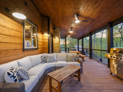 The covered deck with oversized outdoor sectional.