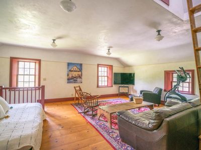 2nd floor living area with TV, Eliptical stepper and daybed.