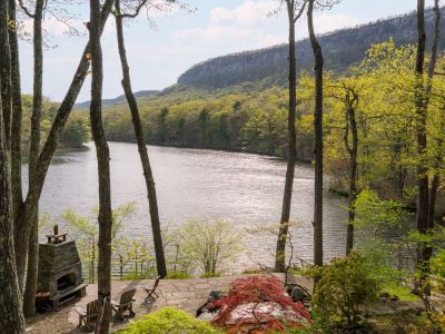 Your private oasis, comprised of terraced garden, outdoor fireplace and lake beyond.