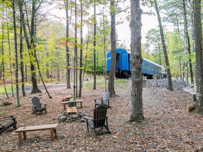 Outside area equipped with a fire pit, solar powered lighting , and an area for grilling and lazing the day away in the hammock.