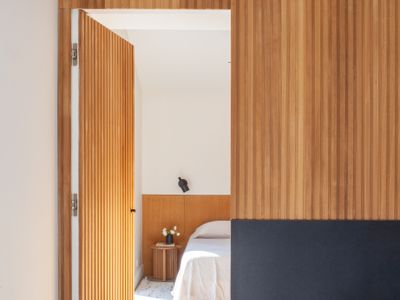 Warm wood-slatted corridor leading to the bedrooms.