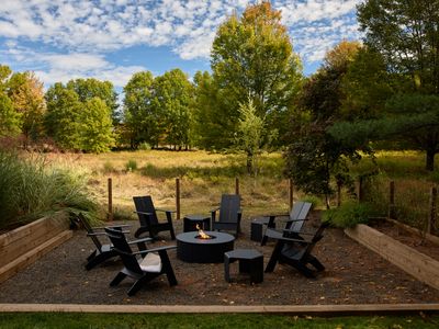 The propane fire pit, steps from the pool and surrounded by 5 private acres.