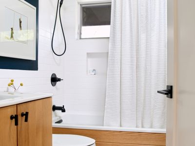 This full bath is off the upstairs hallway in the main house, shared by the two guest bedrooms.