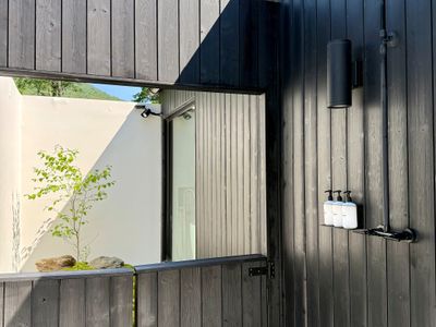 Refresh beneath the open sky in the sleek private outdoor shower.