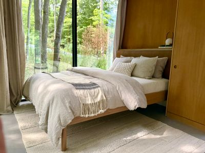 Wake up immersed in nature with panoramic forest views from your bed.