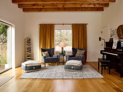 Looking into the music room in the main house, with oversized sliding glass doors to the left that allow you to step out onto the deck.