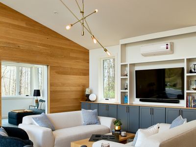 Looking into the pool house living room, with dedicated space for remote work beyond.