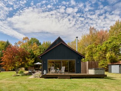Looking towards the hot tub deck and outdoor shower, with sliding doors that enter into the main house living room.