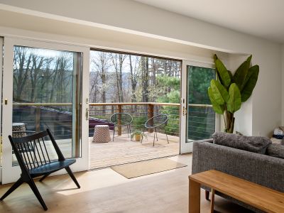 Oversized sliding glass doors open onto the guest house deck on the second story, overlooking the pool.