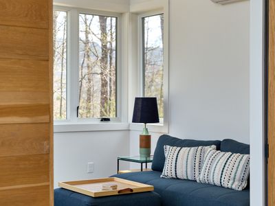 Looking into the work space in the pool house, with a sleeper sofa that allows for additional accommodation.