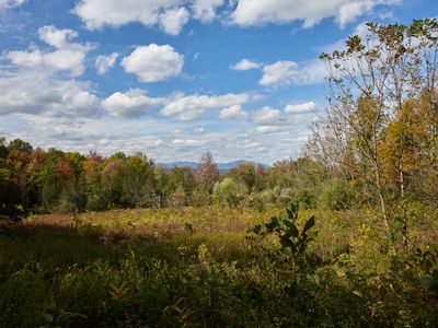 Meadows and mountains on display as you walk down this quiet country road.