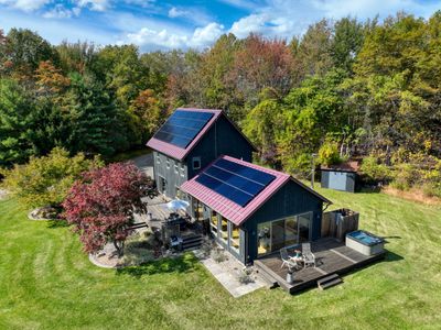 An aerial view of the main house, facing the hot tub deck and outdoor shower, just steps from the living room.