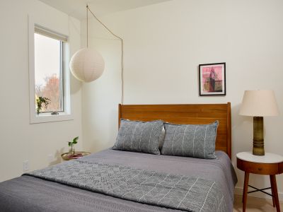 The first bedroom in the guest house, featuring a queen size bed.