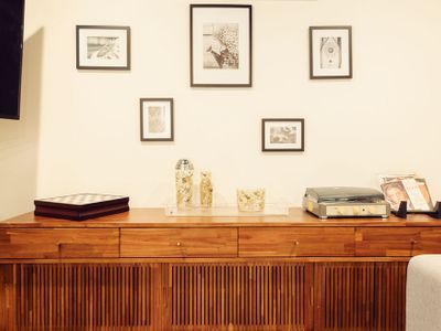 Living area includes a record player with vinyl collection and Marshall speaker.