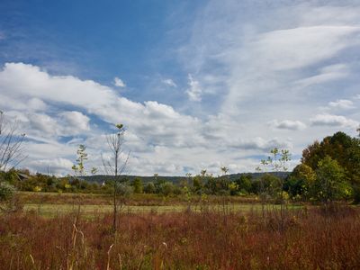 Meadows and mountains on display as you walk down this quiet country road.