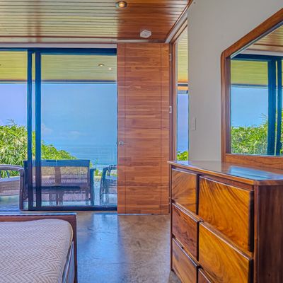 Wake up to ocean views from a bright bedroom connected to the private terrace.