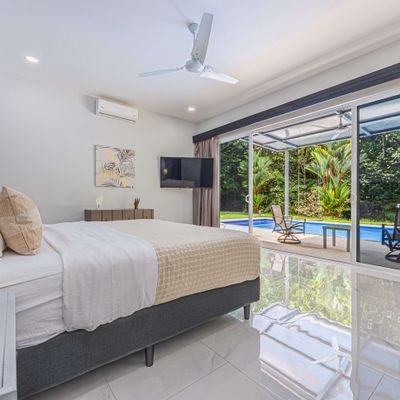 Master Suite with A/C, smart TV, ceiling fan, en-suite bathroom and patio+pool access.