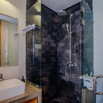 Modern walk-in shower with elegant tile finishes and glass enclosure.