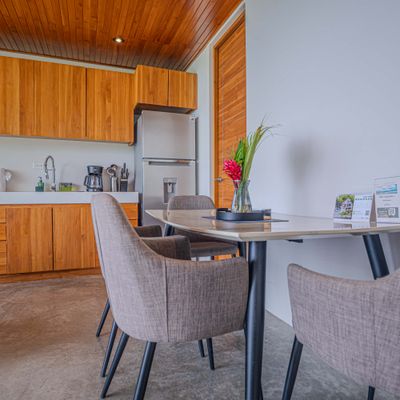 Dining area with comfortable seating, kitchen access, and thoughtful guest details.