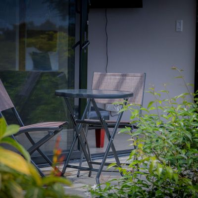 Enjoy quiet moments outdoors in a private dining area surrounded by nature.