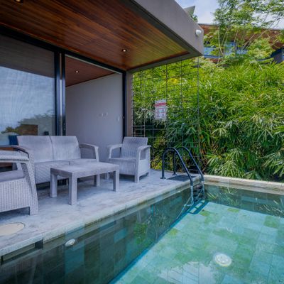 Poolside lounge area with comfortable seating and tropical surroundings.