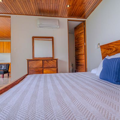 A comfortable bedroom with warm wood details and a calm, restful atmosphere.