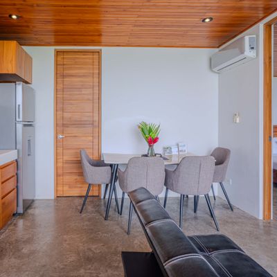 A cozy dining area with modern comforts and warm tropical design details.