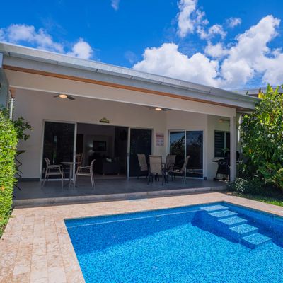 Charming home with a spacious pool area and a convenient grilling space