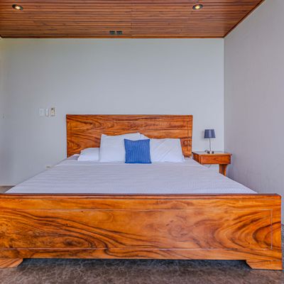 Relax in a calm bedroom with warm wood details and a restful, minimalist design.