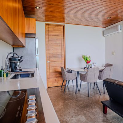 Cook and dine with ease in a thoughtfully equipped kitchen with warm wood details.