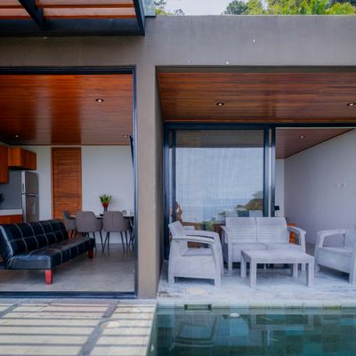 A covered outdoor lounge connects seamlessly with the villa’s indoor living space.