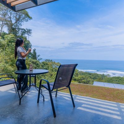 Outdoor dining area with stunning ocean views, perfect for morning coffee or sunset drinks.