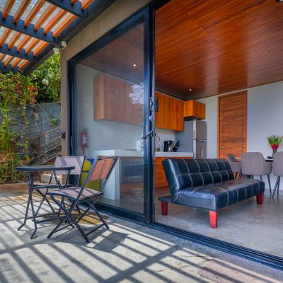 A seamless indoor-outdoor living space connecting the villa, terrace, and pool area.