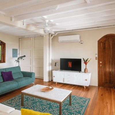 The Living Room/TV Room has a SmartTV, A/C, ceiling fan, floor-to-ceiling patio doors.