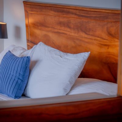 Cozy bedding and natural wood textures create a warm, relaxing bedroom atmosphere.