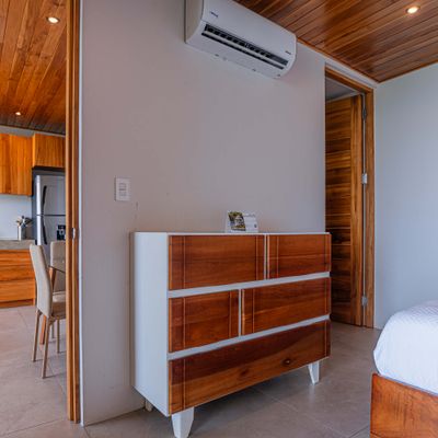 Comfortable bedroom area with storage space and warm wood accents.