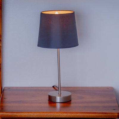 Soft bedside lighting and natural wood finishes create a calm, relaxing bedroom feel.