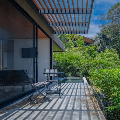 Private terrace dining area surrounded by lush greenery.