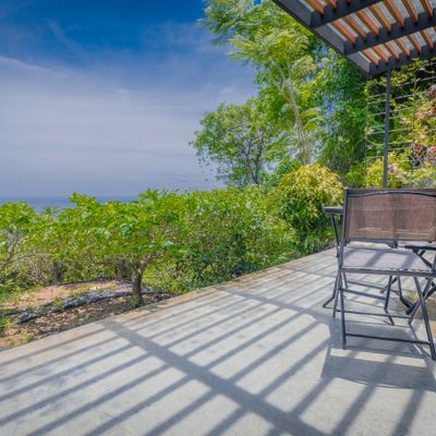 Relax on the open terrace while taking in peaceful ocean and jungle views.