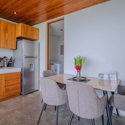 Cozy dining area with fresh tropical flowers and a welcoming atmosphere.