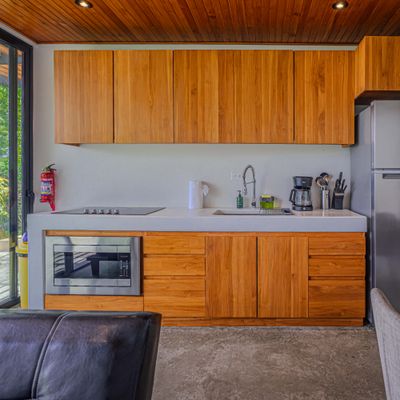 A thoughtfully equipped kitchen with warm wood finishes for easy vacation meals.