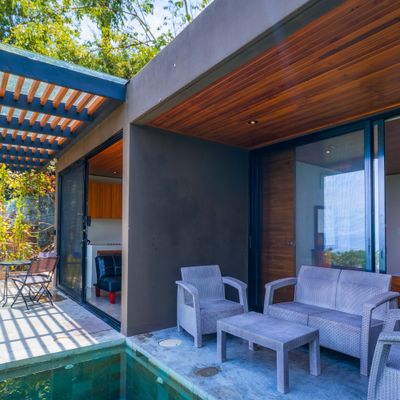 Indoor-outdoor living area with terrace seating and direct access to the villa.