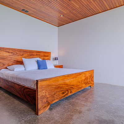 Comfortable bedroom made with natural wood , soft linens, everything you need to relax during your stay.