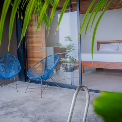 Private terrace with lounge chairs and direct access to the bedroom.