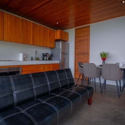 A bright open-plan living area with a fully equipped kitchen and relaxed seating.
