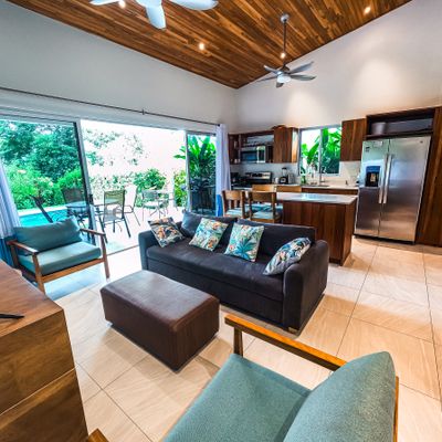 A cozy living room with large windows offering stunning views of the pool.