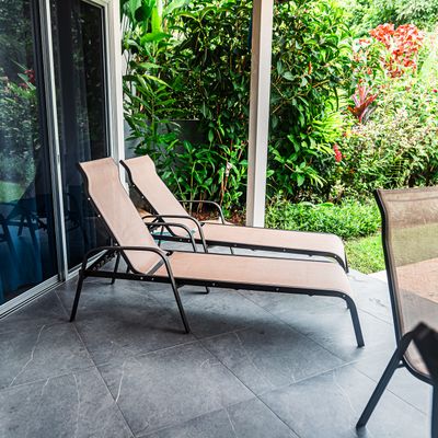 Elegant outdoor furniture perfect for lounging by the pool.